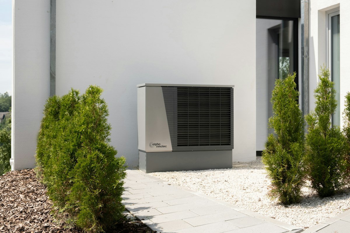 Air source heat pump outside a modern home